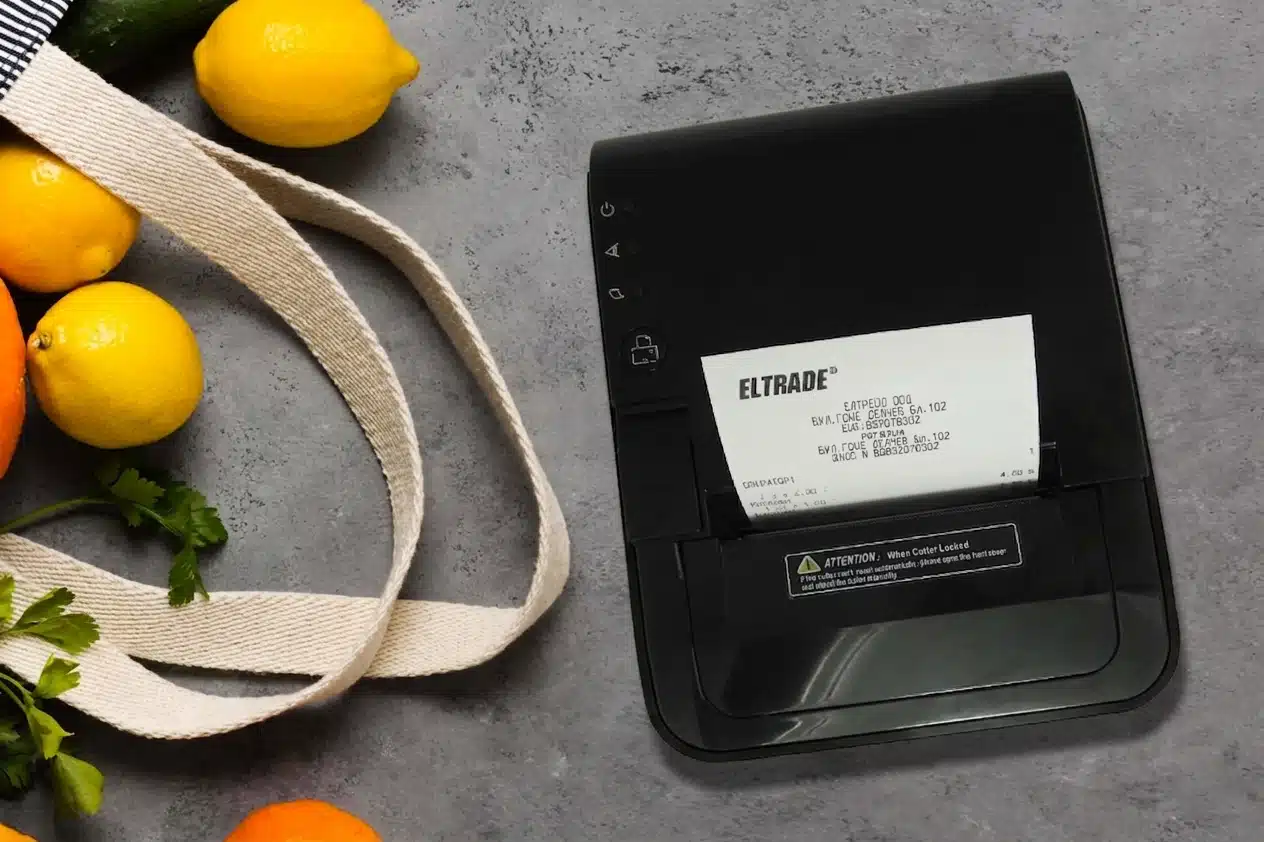 Advertising image of a fiscal printer prp 250 Eltrade, among a bag of fruits
